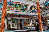 Vientiane, Laos - Pha That Luang, among the Other structures on the ground there is an open sala decorated with brightly colored paintings.  